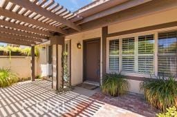 25723 Player Dr, Valencia, CA 91355 - property entrance with a pergola and a porch