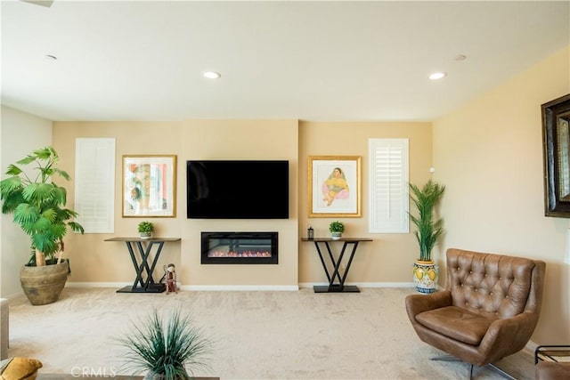 11534 Alana Ln, Beaumont, CA 92223 - sitting room with recessed lighting, a glass covered fireplace, carpet floors, and baseboards