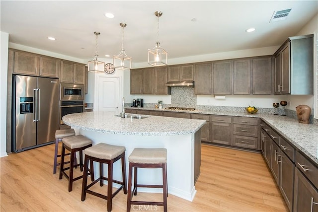 11534 Alana Ln, Beaumont, CA 92223 - kitchen featuring a kitchen breakfast bar, a sink, visible vents, recessed lighting, and appliances with stainless steel finishes