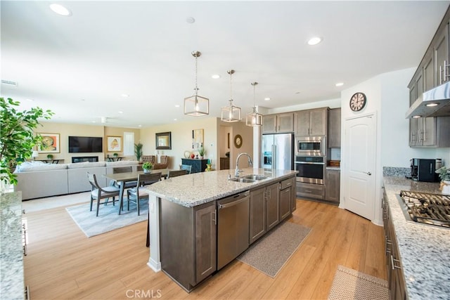 11534 Alana Ln, Beaumont, CA 92223 - kitchen with a sink, light wood-type flooring, recessed lighting, an island with sink, and appliances with stainless steel finishes
