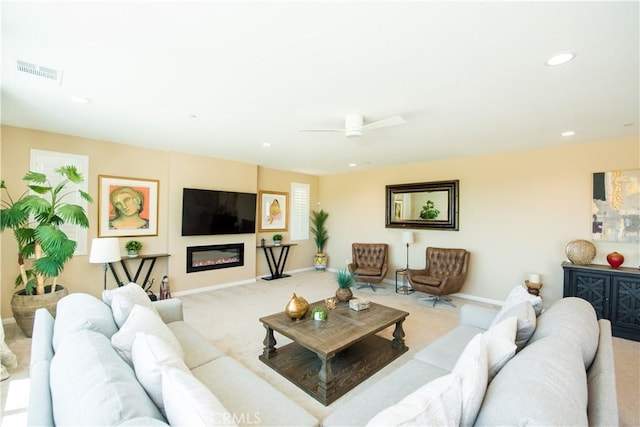 11534 Alana Ln, Beaumont, CA 92223 - carpeted living area with baseboards, visible vents, a glass covered fireplace, recessed lighting, and ceiling fan