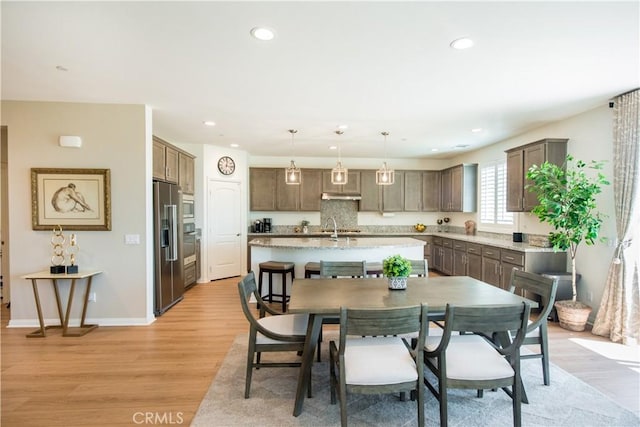 11534 Alana Ln, Beaumont, CA 92223 - dining space featuring light wood-style flooring, baseboards, and recessed lighting