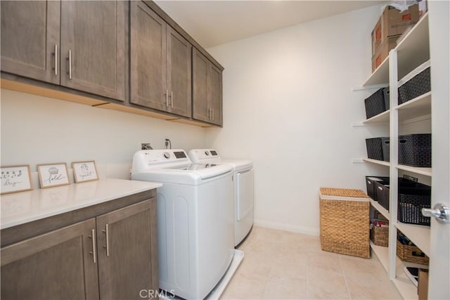 11534 Alana Ln, Beaumont, CA 92223 - laundry room featuring cabinet space, light tile patterned floors, baseboards, and separate washer and dryer