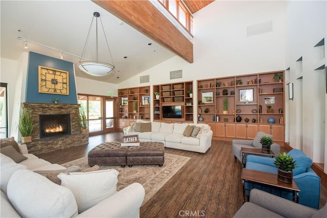 11534 Alana Ln, Beaumont, CA 92223 - living room with high vaulted ceiling, rail lighting, a stone fireplace, and visible vents