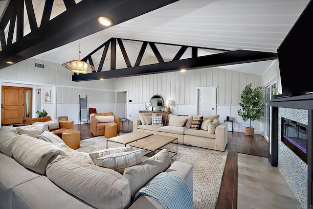 1105 Fulton Rd, San Marcos, CA 92069 - living area with beam ceiling, a tiled fireplace, visible vents, wood finished floors, and a decorative wall