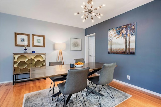 4723 E 3rd St, Long Beach, CA 90814 - dining area with baseboards, wood finished floors, and a chandelier
