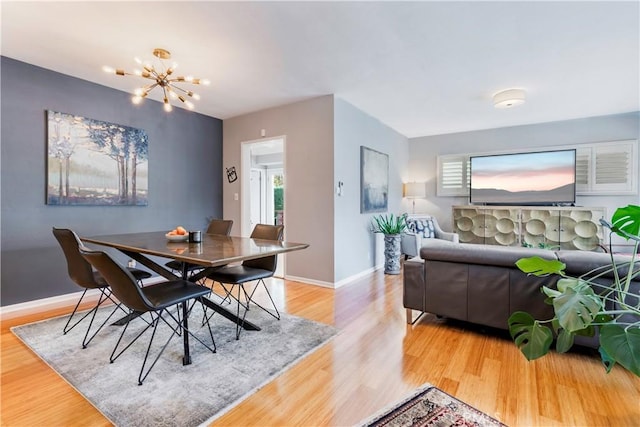 4723 E 3rd St, Long Beach, CA 90814 - dining area with baseboards, wood finished floors, a wealth of natural light, and a notable chandelier