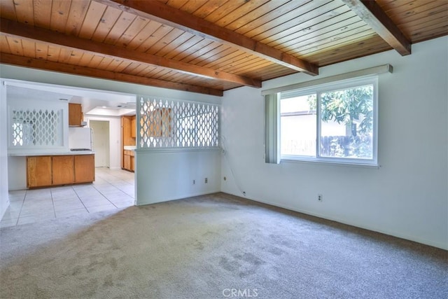 unfurnished living room with light colored carpet, wooden ceiling, baseboards, beamed ceiling, and light tile patterned flooring