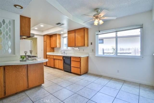 kitchen featuring light countertops, a textured ceiling, visible vents, and dishwasher