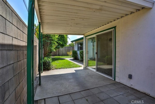 view of patio / terrace featuring a fenced backyard and a carport