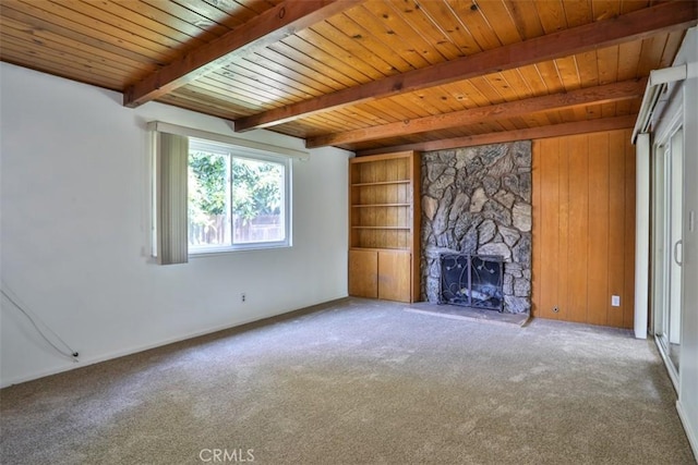unfurnished living room featuring wood ceiling, a fireplace, baseboards, beamed ceiling, and carpet flooring