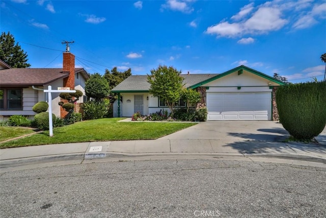 single story home with an attached garage, concrete driveway, and a front yard