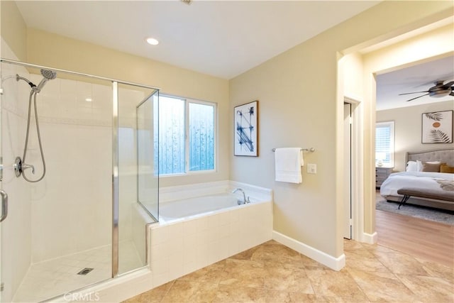 ensuite bathroom featuring a stall shower, a wealth of natural light, and a garden tub