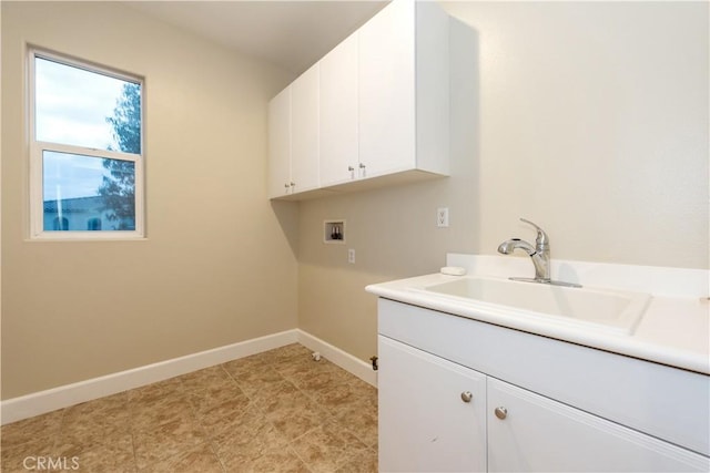 laundry room with washer hookup, a sink, cabinet space, and baseboards