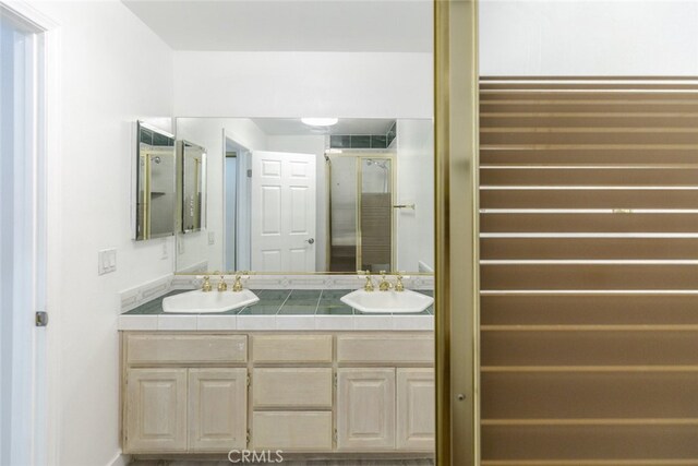 7928 Bellaire Ave, North Hollywood, CA 91605 - full bathroom featuring visible vents, a sink, double vanity, and a stall shower
