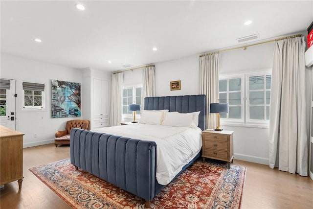 bedroom with light wood finished floors, baseboards, recessed lighting, and visible vents