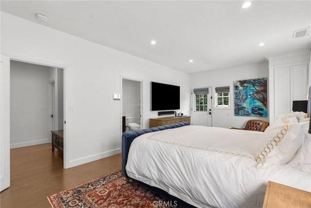 bedroom featuring recessed lighting, wood finished floors, visible vents, and baseboards