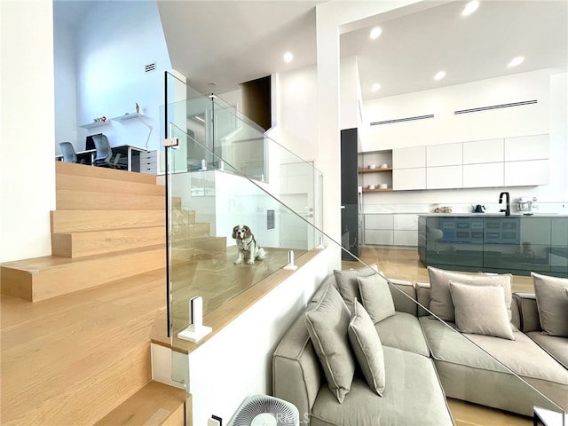 stairs with visible vents, recessed lighting, and wood finished floors
