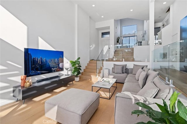living area with stairway, recessed lighting, and wood finished floors