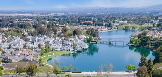 birds eye view of property with a water view and a residential view