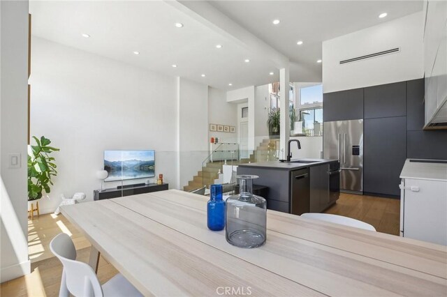 15 Waterway Unit 11, Irvine, CA 92614 - kitchen featuring a sink, stainless steel refrigerator with ice dispenser, dishwashing machine, modern cabinets, and wood finished floors