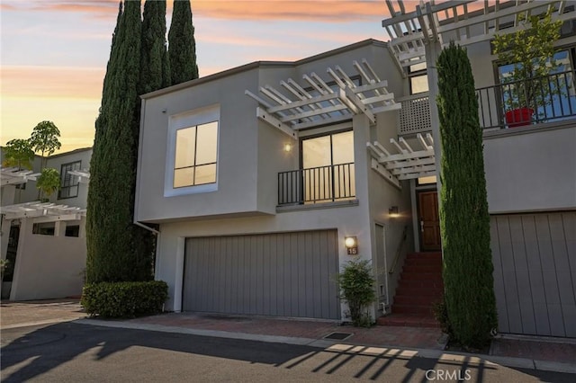 15 Waterway Unit 11, Irvine, CA 92614 - contemporary home featuring stucco siding, a garage, decorative driveway, and a pergola