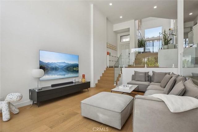 15 Waterway Unit 11, Irvine, CA 92614 - living room with wood finished floors, a towering ceiling, stairway, recessed lighting, and baseboards