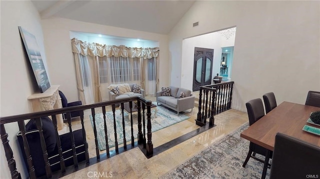 interior space with visible vents, high vaulted ceiling, and baseboards