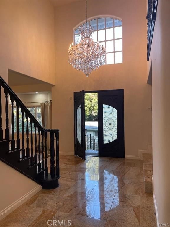 15020 Encanto Dr, Sherman Oaks, CA 91403 - foyer with baseboards, a chandelier, a high ceiling, marble tiled flooring, and stairs