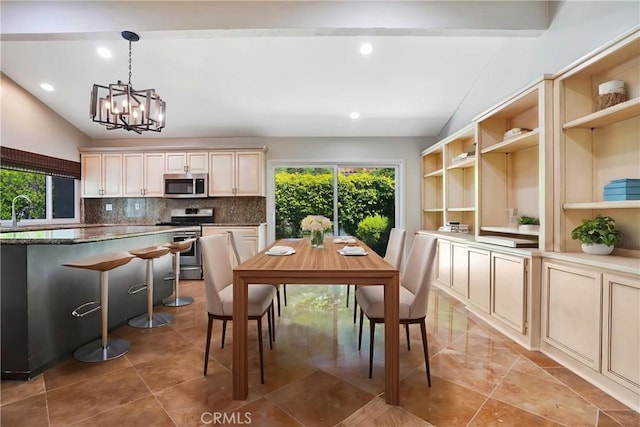dining area featuring lofted ceiling, a chandelier, and recessed lighting
