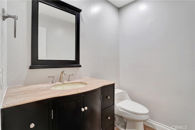 half bathroom featuring toilet and vanity