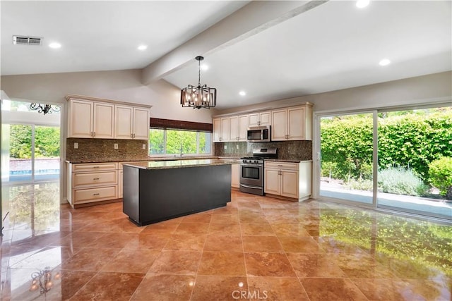 kitchen with lofted ceiling with beams, appliances with stainless steel finishes, tasteful backsplash, and visible vents