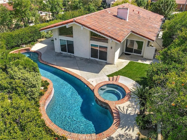view of swimming pool with a patio area and a pool with connected hot tub