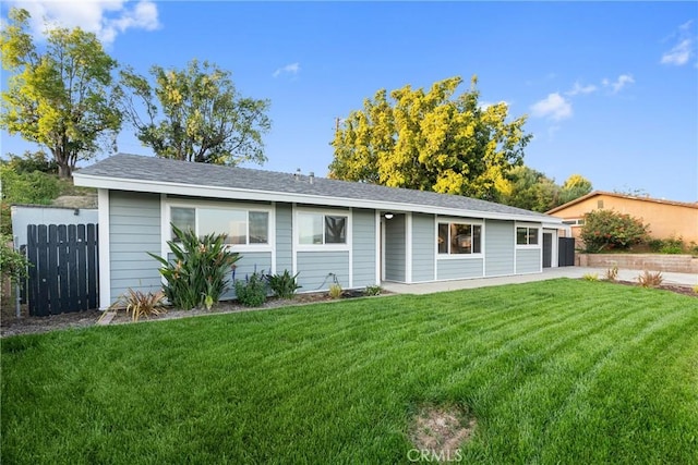view of front of property with fence, a garage, and a front yard