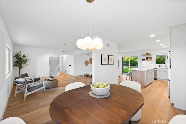 dining room featuring recessed lighting, light wood-type flooring, visible vents, and stairway