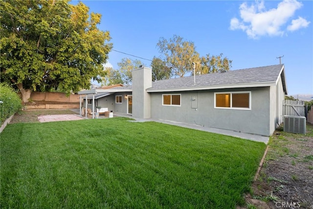 back of property with a fenced backyard, central air condition unit, a chimney, a patio, and stucco siding