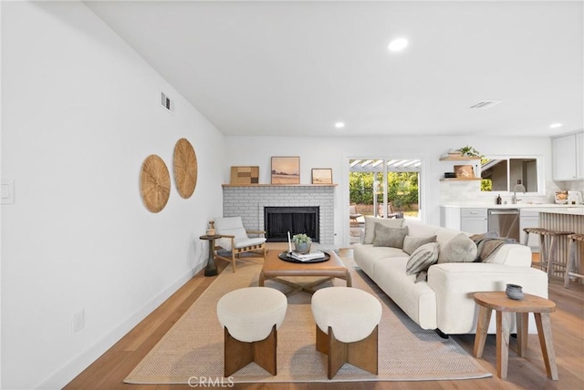 4421 Hempstead St, Simi Valley, CA 93063 - living area with a fireplace, light wood-style flooring, recessed lighting, and baseboards