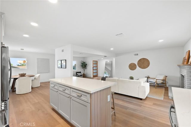 4421 Hempstead St, Simi Valley, CA 93063 - kitchen featuring open floor plan, a brick fireplace, light wood-type flooring, and recessed lighting