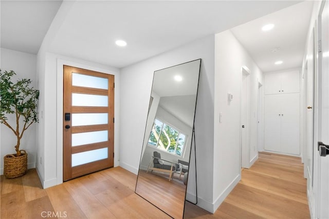 entryway featuring recessed lighting, light wood-style floors, and baseboards