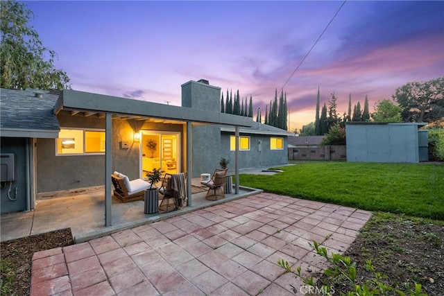 4421 Hempstead St, Simi Valley, CA 93063 - rear view of house featuring a patio area, a lawn, a chimney, and stucco siding