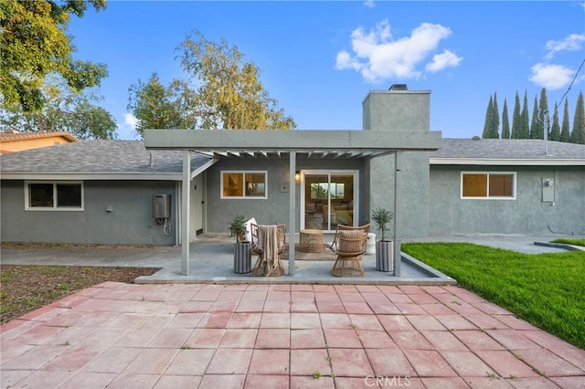 4421 Hempstead St, Simi Valley, CA 93063 - rear view of house featuring a patio area, stucco siding, a chimney, and a yard