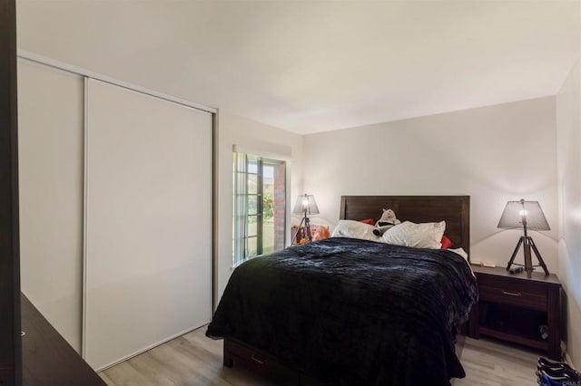 bedroom with a closet and light wood-style flooring