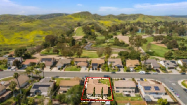 aerial view featuring a residential view, a mountain view, and golf course view