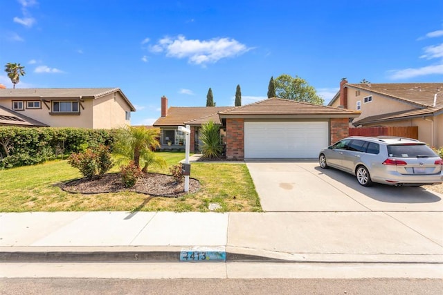 ranch-style house with driveway, a tile roof, a garage, brick siding, and a front lawn