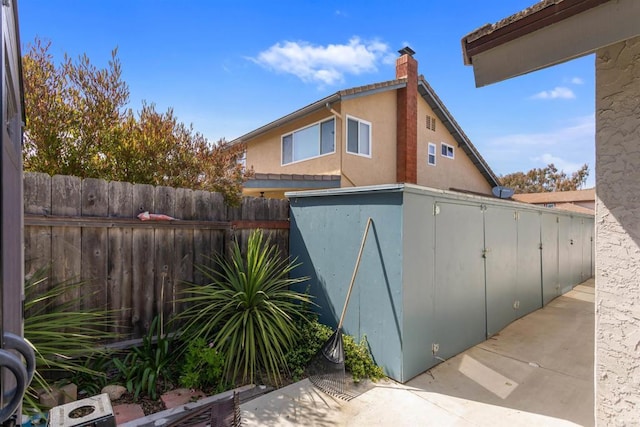 view of outdoor structure featuring fence