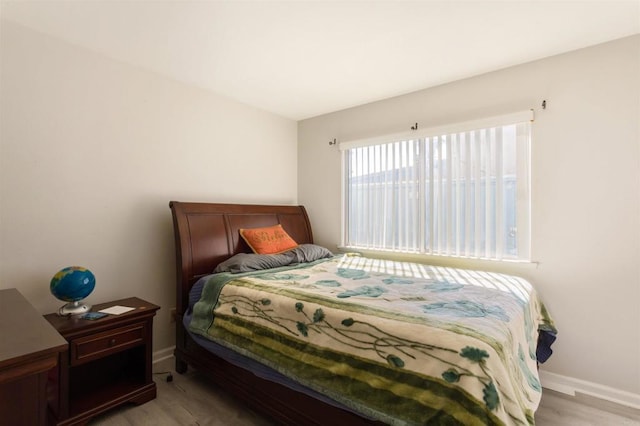 bedroom with baseboards and light wood-style flooring