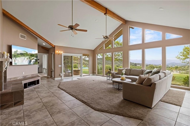living room with beam ceiling, a mountain view, visible vents, a ceiling fan, and high vaulted ceiling