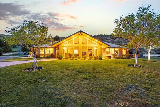 view of front of property with a yard and fence