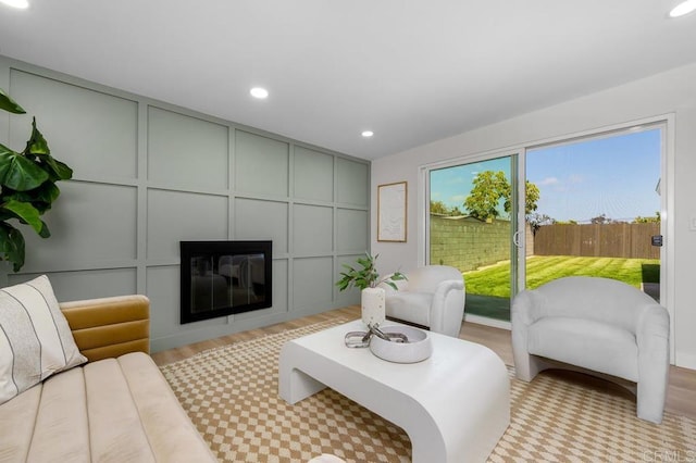 2263 Finch Ln, San Diego, CA 92123 - living room with a decorative wall, a glass covered fireplace, recessed lighting, and wood finished floors