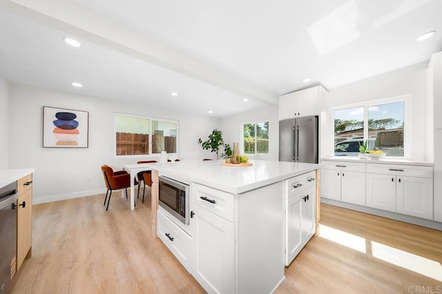 2263 Finch Ln, San Diego, CA 92123 - kitchen with stainless steel appliances, light countertops, light wood-type flooring, white cabinets, and recessed lighting